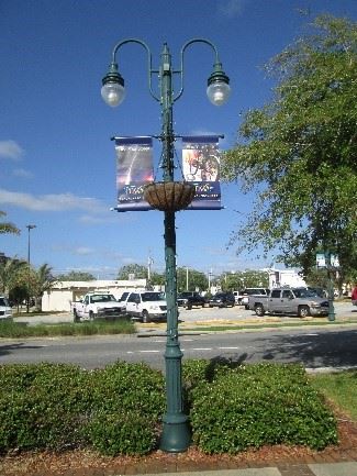 Photo of a decorative streetlight pole with banners 

hung on the sides.