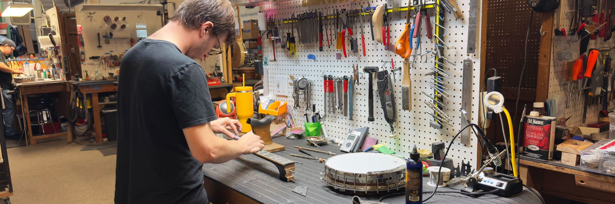 man building banjo