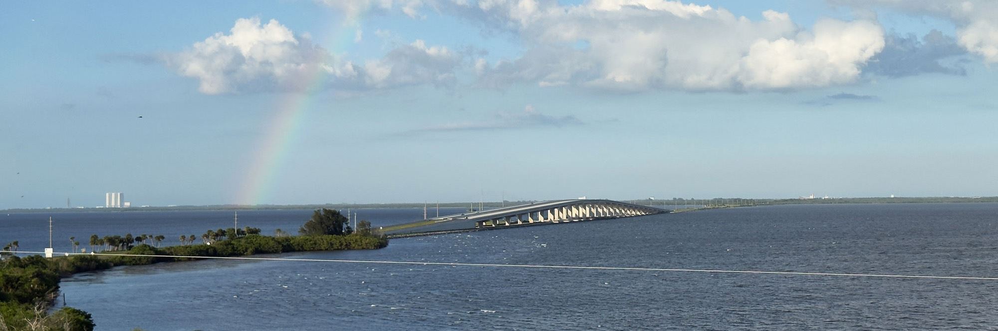 aerial view of bridge with rainbow